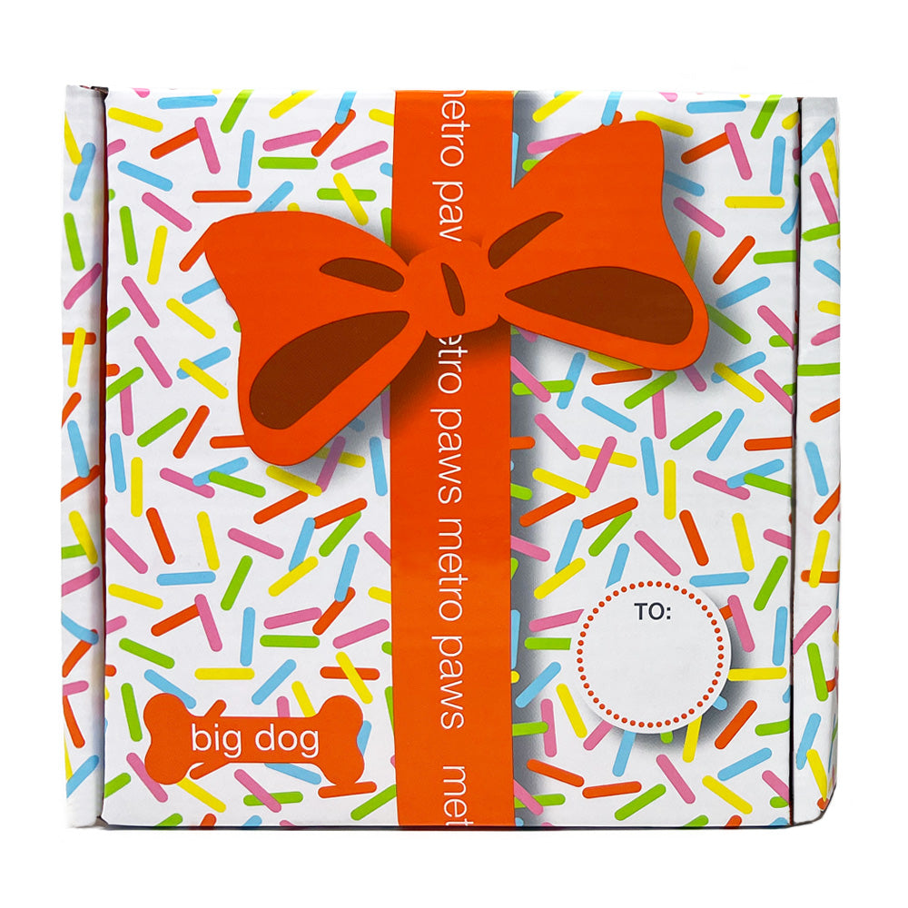 Front of Metro Pawty Box for Big Dogs, featuring sprinkles print, orange ribbon, and label