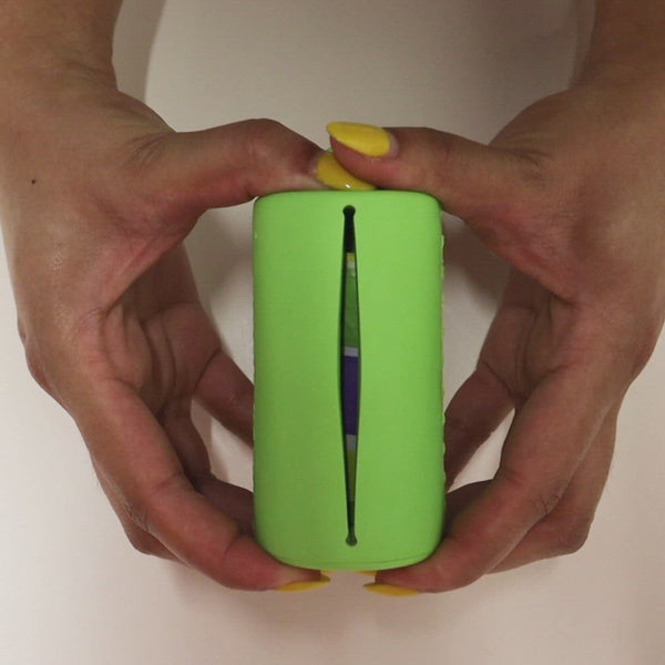 Hands squeezing The Poopcase in Lime to refill and then pull poop bag out