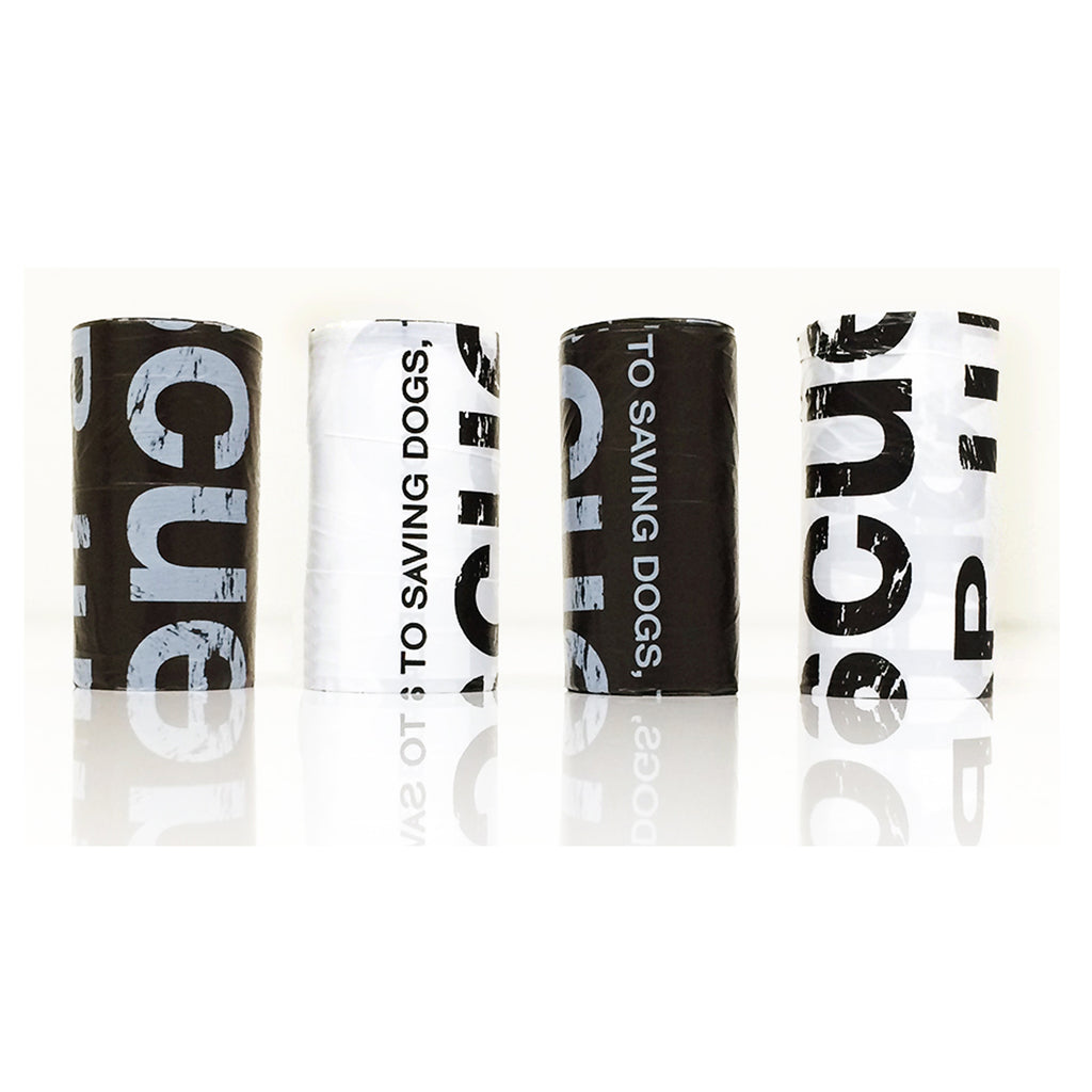 Black and white rolls of Love & Licks GOOD KARMA Poop Bags, dog waste bags that give back